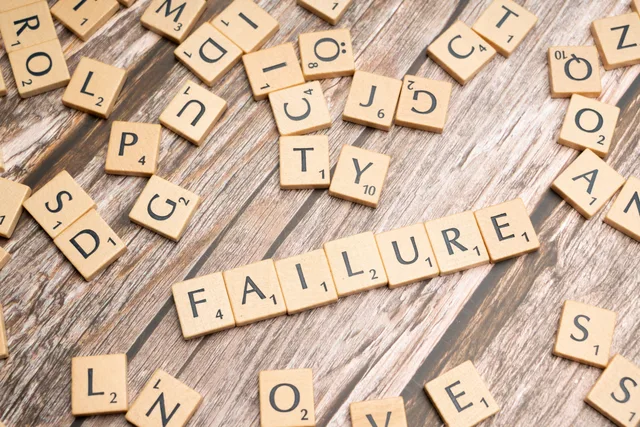 Wooden letter tiles spelling 'failure' on a wooden table, representing challenges. Email marketing software measurement mistakes