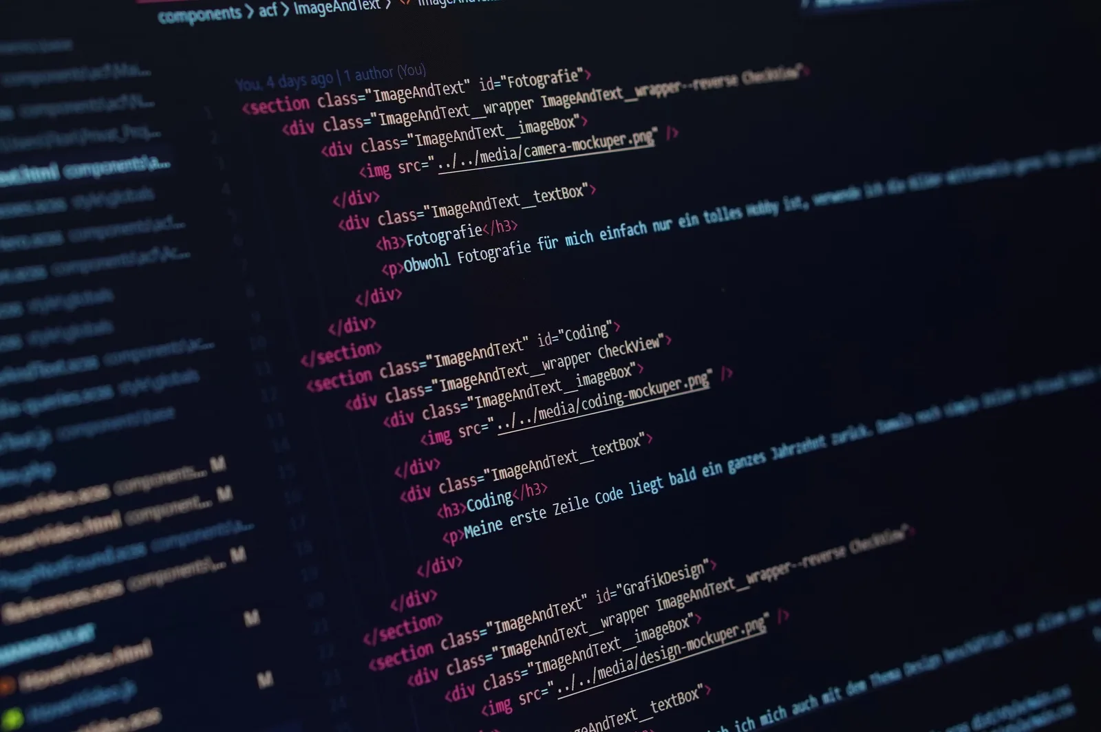 Close-up view of HTML code displayed on a dark screen, showcasing coding concepts.