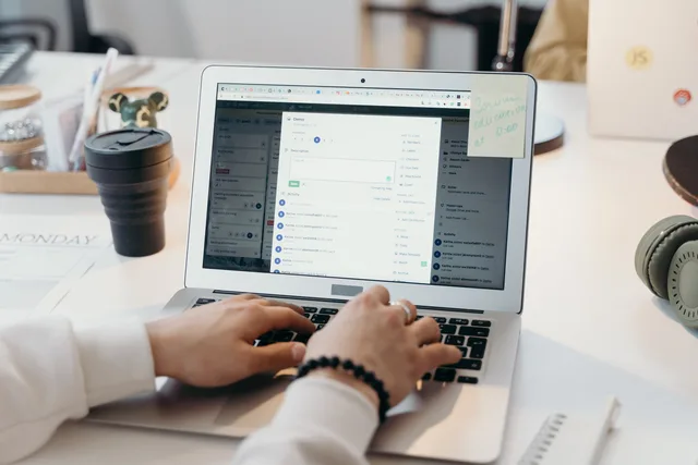 A person typing on a laptop in a bright, modern office setting, showing productivity and technology. Six steps that take an email campaign from open job to recorded closure