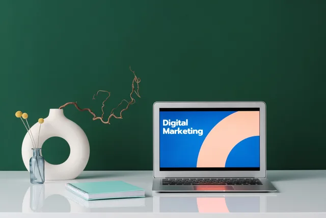 A modern workspace featuring a laptop displaying 'Digital Marketing' against a green wall. Email marketing software for UK ecommerce: platforms and features